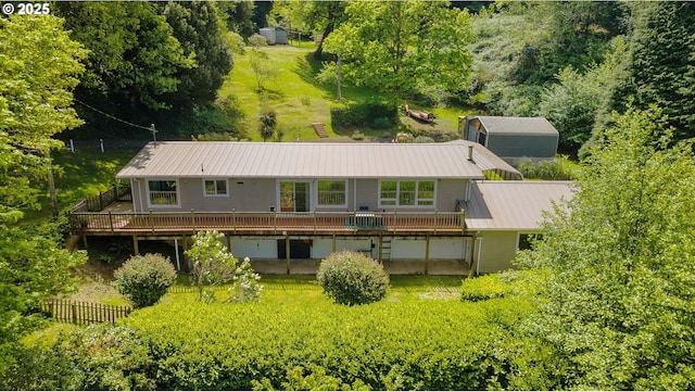 63642 Flanagan Rd, Coos Bay, OR 97420 - rear view of house with a wooden deck, metal roof, and fence