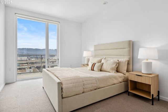 bedroom featuring baseboards, carpet flooring, a mountain view, and access to exterior