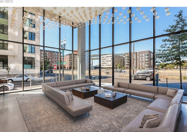 interior space featuring a high ceiling, floor to ceiling windows, and a city view