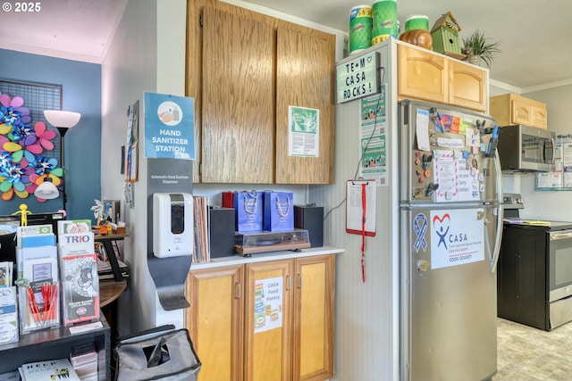 kitchen with appliances with stainless steel finishes, light countertops, and ornamental molding