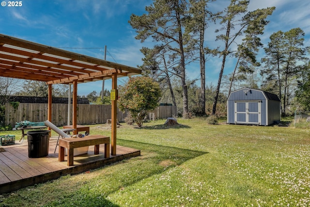 view of yard featuring a wooden deck, a pergola, a fenced backyard, and a storage shed