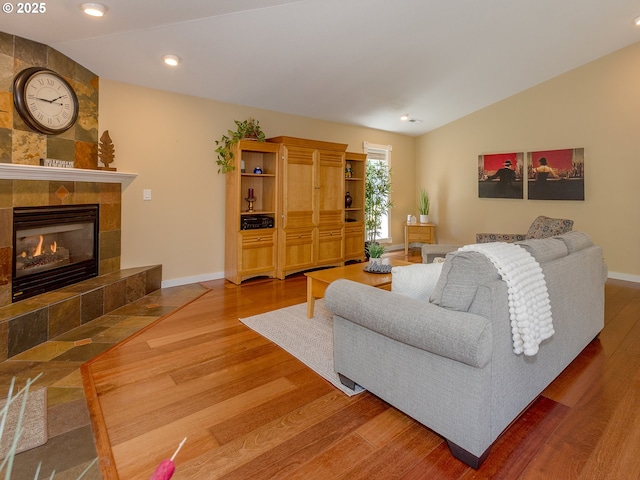 1802 NW Ogden St, Camas, WA 98607 - living room featuring wood finished floors, baseboards, vaulted ceiling, a tile fireplace, and recessed lighting
