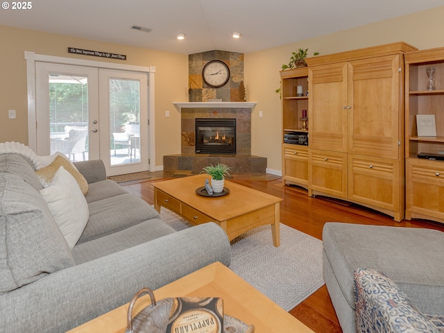 1802 NW Ogden St, Camas, WA 98607 - living room with french doors, wood finished floors, recessed lighting, a tile fireplace, and baseboards