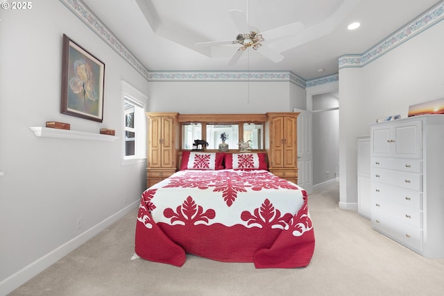 bedroom with light carpet, baseboards, recessed lighting, a raised ceiling, and ceiling fan