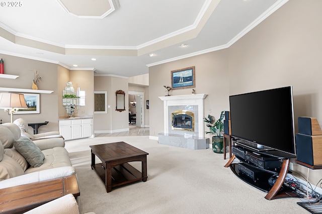 living area with ornamental molding, light carpet, a premium fireplace, recessed lighting, and a raised ceiling