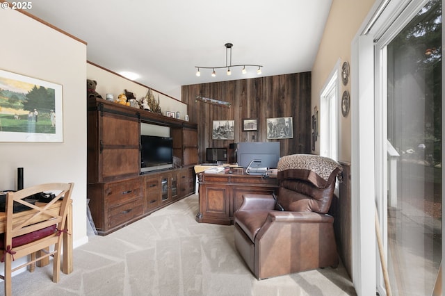 living room featuring light colored carpet, a desk, and wooden walls