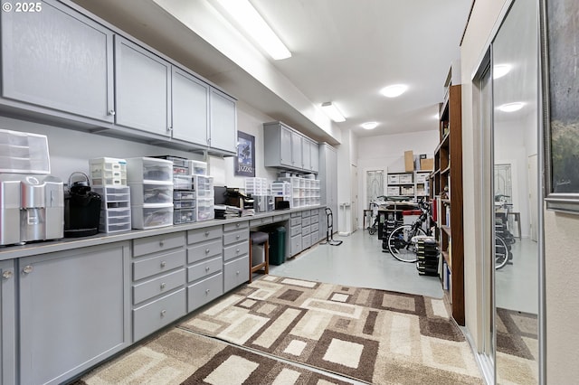 kitchen featuring finished concrete floors, gray cabinets, and light countertops