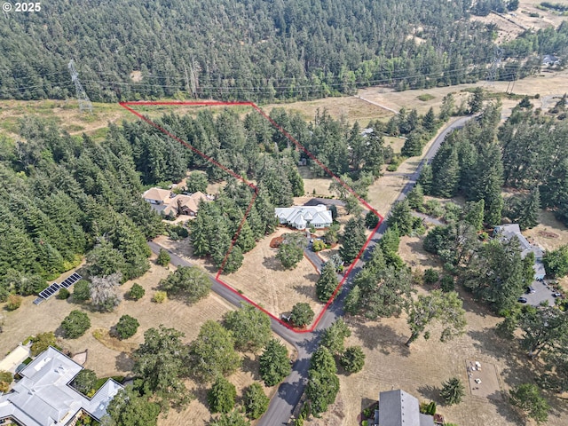 birds eye view of property featuring a view of trees