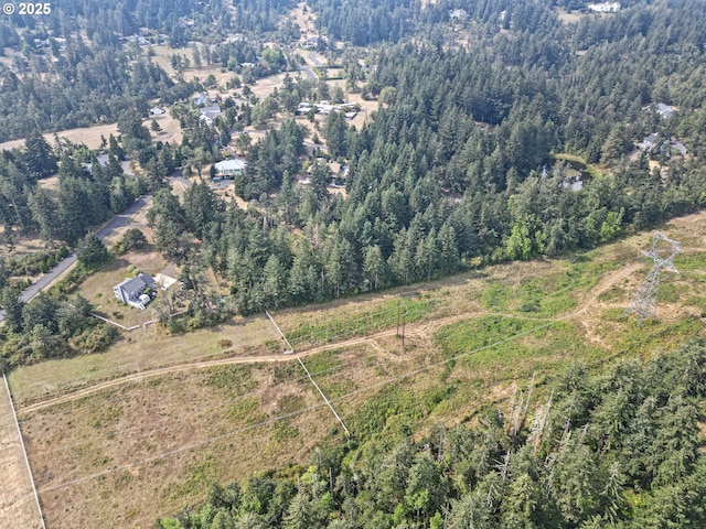 aerial view of property's location with a heavily wooded area