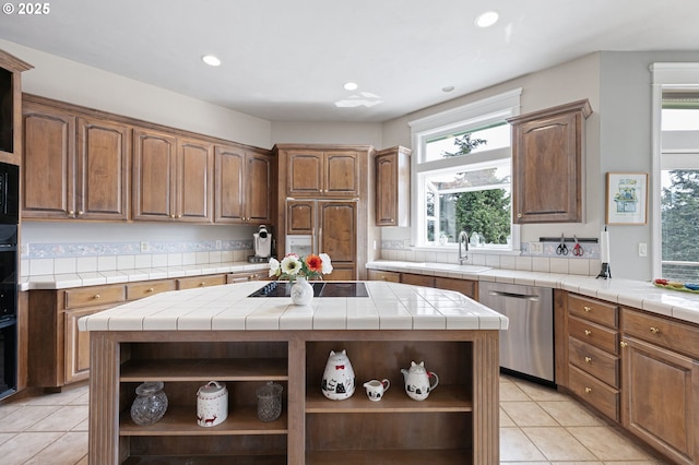 kitchen featuring open shelves, black appliances, a sink, tile counters, and light tile patterned flooring