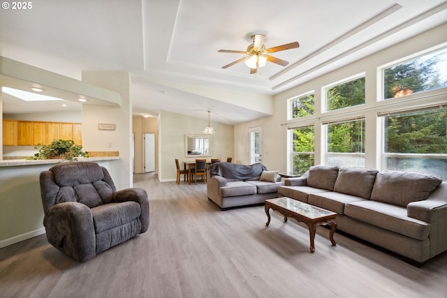 68226 Iris Rd, North Bend, OR 97459 - living room with light wood finished floors, ceiling fan, recessed lighting, a raised ceiling, and baseboards