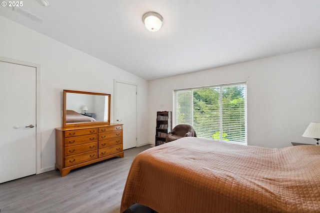 68226 Iris Rd, North Bend, OR 97459 - bedroom with lofted ceiling and light wood-style floors