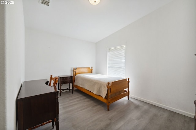 68226 Iris Rd, North Bend, OR 97459 - bedroom with lofted ceiling, wood finished floors, and baseboards