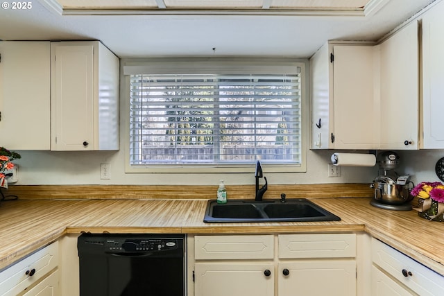 kitchen with sink, white cabinetry, and black dishwasher