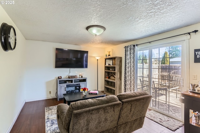 living room featuring hardwood / wood-style flooring and a textured ceiling