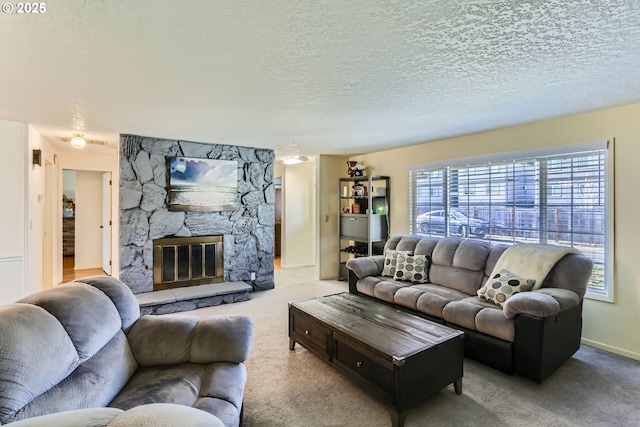 living room with light colored carpet, a textured ceiling, and a stone fireplace