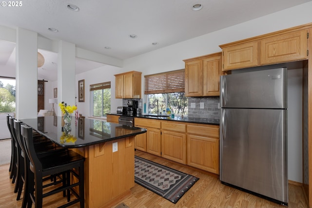 4080 Cunningham Dr, Mount Hood Prkdl, OR 97041 - kitchen with freestanding refrigerator, a kitchen island, light wood-style floors, dishwashing machine, and a sink