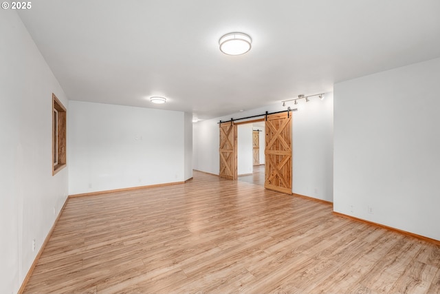 250 Valley View Rd, Sutherlin, OR 97479 - empty room featuring wood finished floors, a barn door, and baseboards