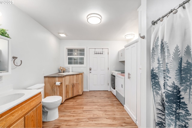 250 Valley View Rd, Sutherlin, OR 97479 - full bathroom featuring washing machine and dryer, two vanities, wood finished floors, toilet, and curtained shower