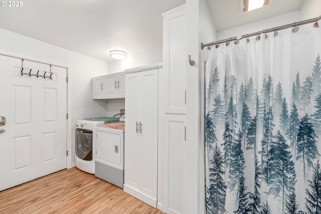 250 Valley View Rd, Sutherlin, OR 97479 - washroom featuring washing machine and clothes dryer, cabinet space, and light wood-style floors