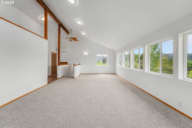 250 Valley View Rd, Sutherlin, OR 97479 - unfurnished living room featuring carpet, plenty of natural light, beamed ceiling, baseboards, and a ceiling fan