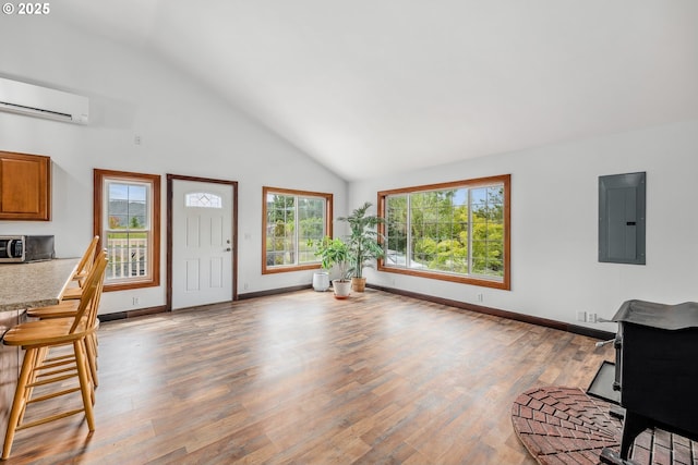 250 Valley View Rd, Sutherlin, OR 97479 - entryway with electric panel, an AC wall unit, high vaulted ceiling, light wood-style floors, and baseboards