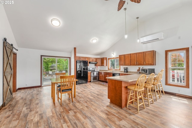 250 Valley View Rd, Sutherlin, OR 97479 - kitchen with appliances with stainless steel finishes, brown cabinets, a peninsula, a wall mounted air conditioner, and a barn door