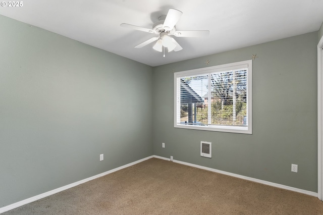 empty room featuring ceiling fan, carpet floors, and baseboards