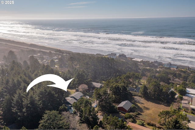 drone / aerial view featuring a water view and a beach view