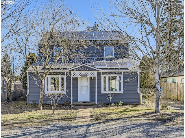 view of front of property featuring solar panels