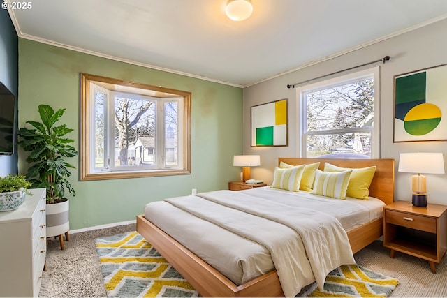 carpeted bedroom with ornamental molding