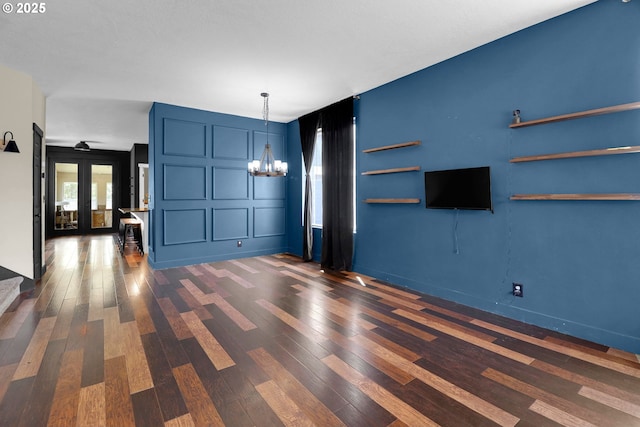 5416 Wales Dr, Eugene, OR 97402 - unfurnished living room with a chandelier, dark wood-style floors, and french doors