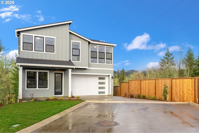 view of front of home with a garage and a front lawn