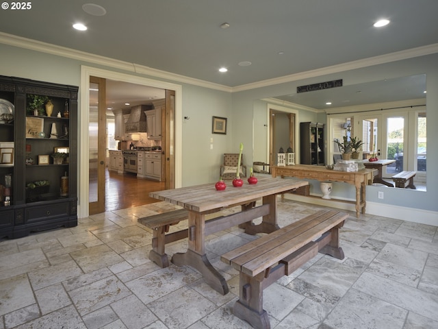 dining space with crown molding