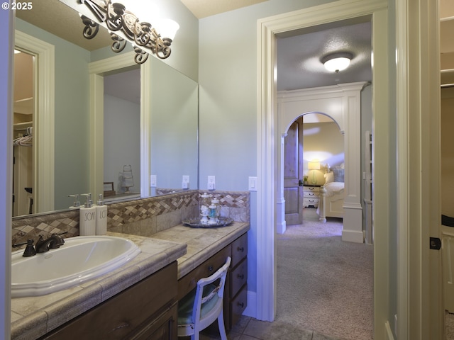 bathroom featuring vanity and backsplash