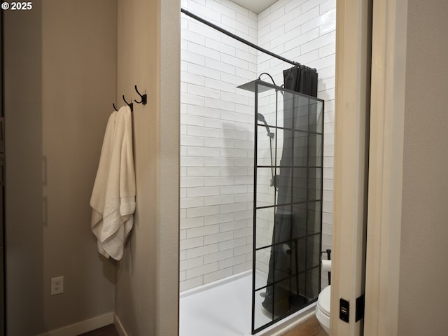 bathroom featuring toilet and a shower with shower curtain