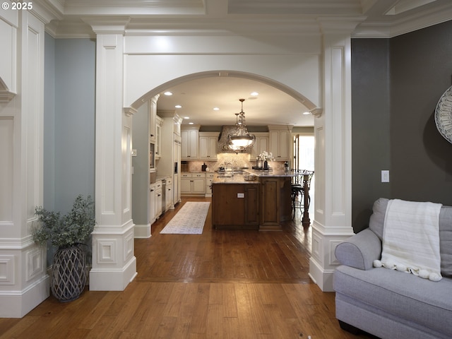 interior space featuring ornamental molding and dark hardwood / wood-style floors