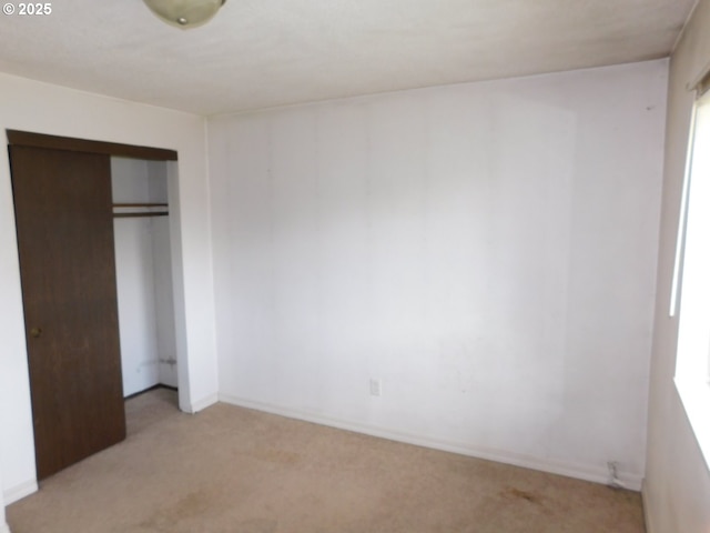573 SW Harbor Pl, Warrenton, OR 97146 - unfurnished bedroom featuring light carpet, a closet, and baseboards