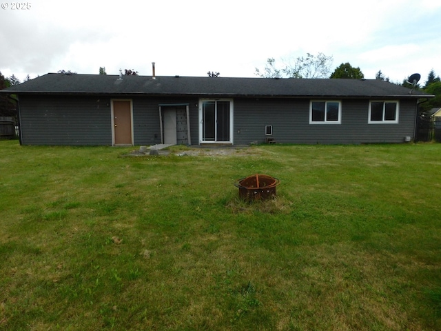 573 SW Harbor Pl, Warrenton, OR 97146 - rear view of property with a fire pit and a lawn