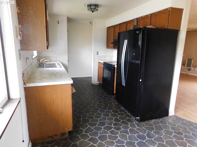 573 SW Harbor Pl, Warrenton, OR 97146 - kitchen featuring black appliances, a sink, light countertops, brown cabinets, and under cabinet range hood
