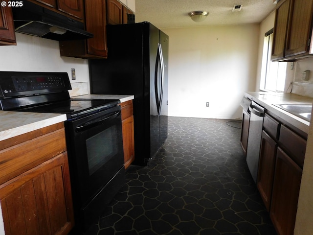 573 SW Harbor Pl, Warrenton, OR 97146 - kitchen featuring black range with electric cooktop, under cabinet range hood, stainless steel dishwasher, light countertops, and a textured ceiling