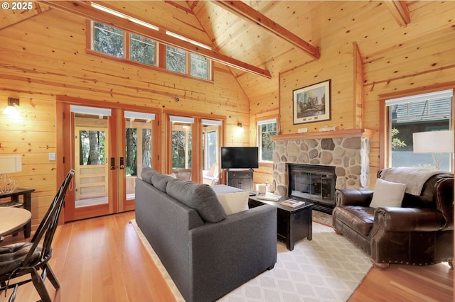 living room with wooden ceiling, french doors, wood walls, and light wood-style flooring