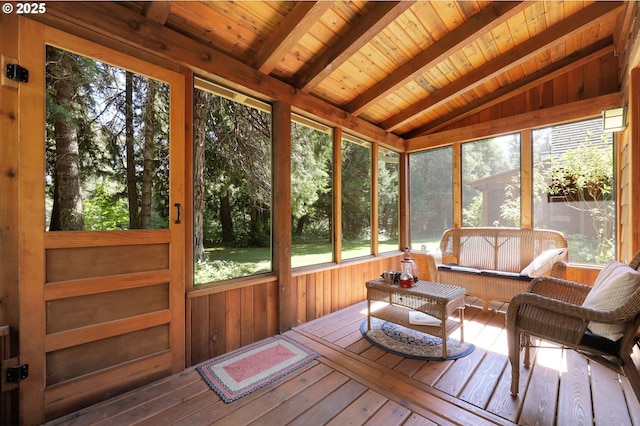 sunroom / solarium featuring outdoor lounge area, plenty of natural light, and beam ceiling