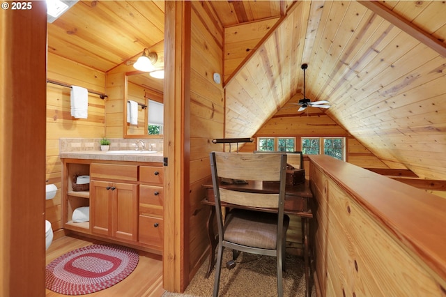 bathroom featuring vanity, wooden walls, and wooden ceiling