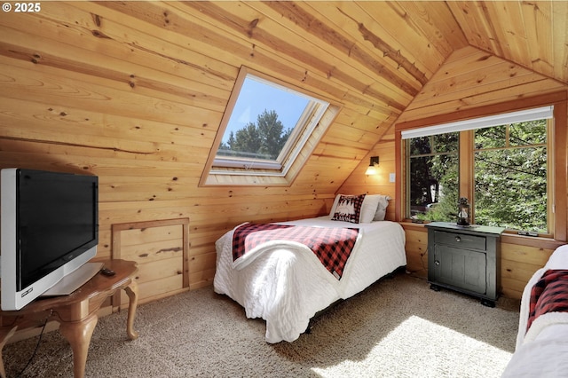 carpeted bedroom with vaulted ceiling with skylight, wood ceiling, and wood walls