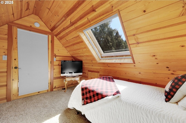 bedroom featuring vaulted ceiling with skylight, wood ceiling, carpet, and wooden walls