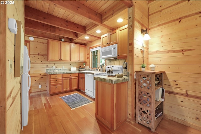 kitchen with white appliances, wooden walls, light wood-type flooring, tile countertops, and wood ceiling