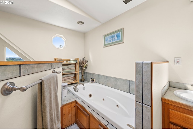 bathroom featuring vanity and a bath