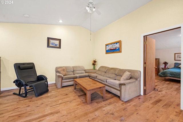 living room featuring ceiling fan, lofted ceiling, and light hardwood / wood-style flooring