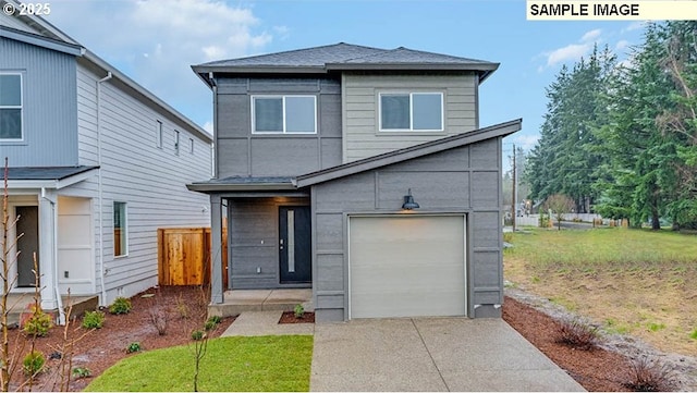 view of front of property featuring driveway, an attached garage, fence, and a front lawn